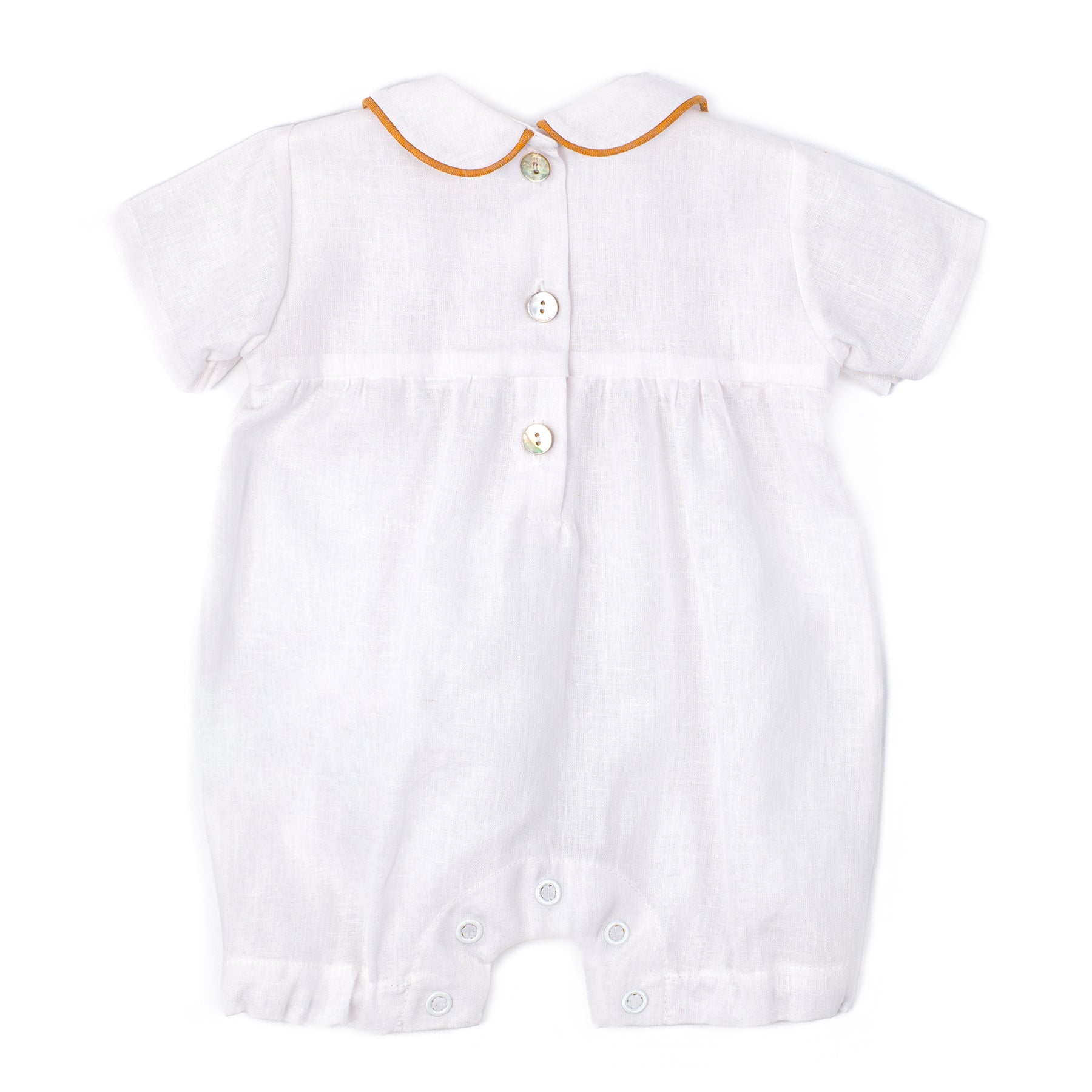 White baby romper with orange trim on a white background