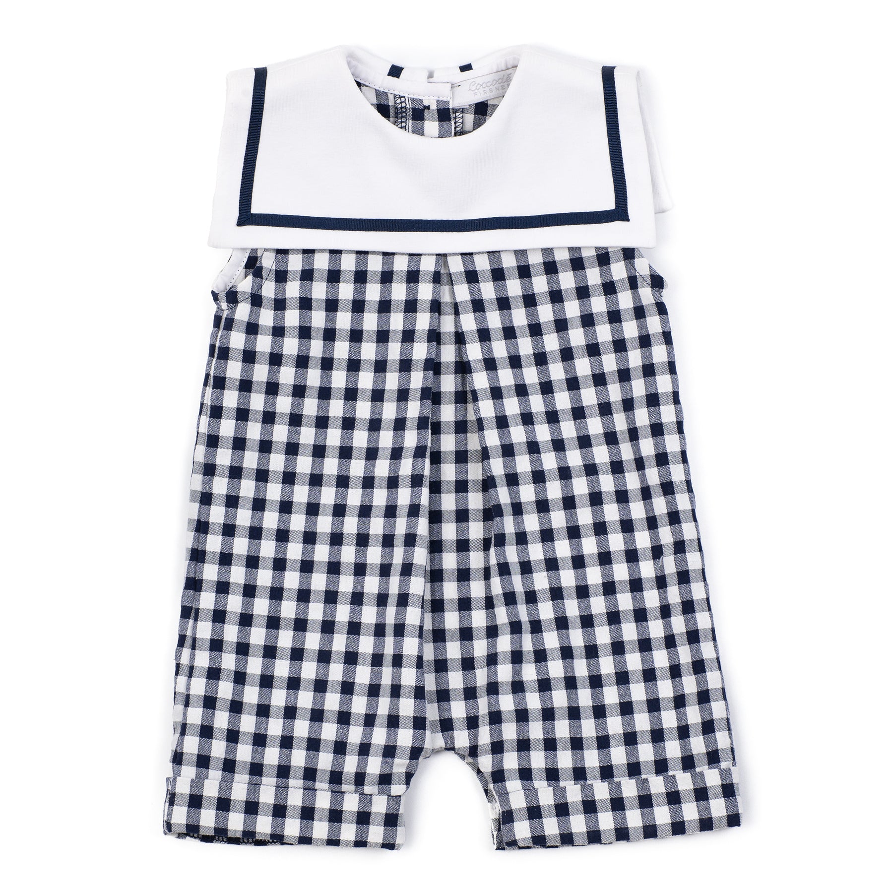 Children's outfit with white top and navy checkered shorts on a white background
