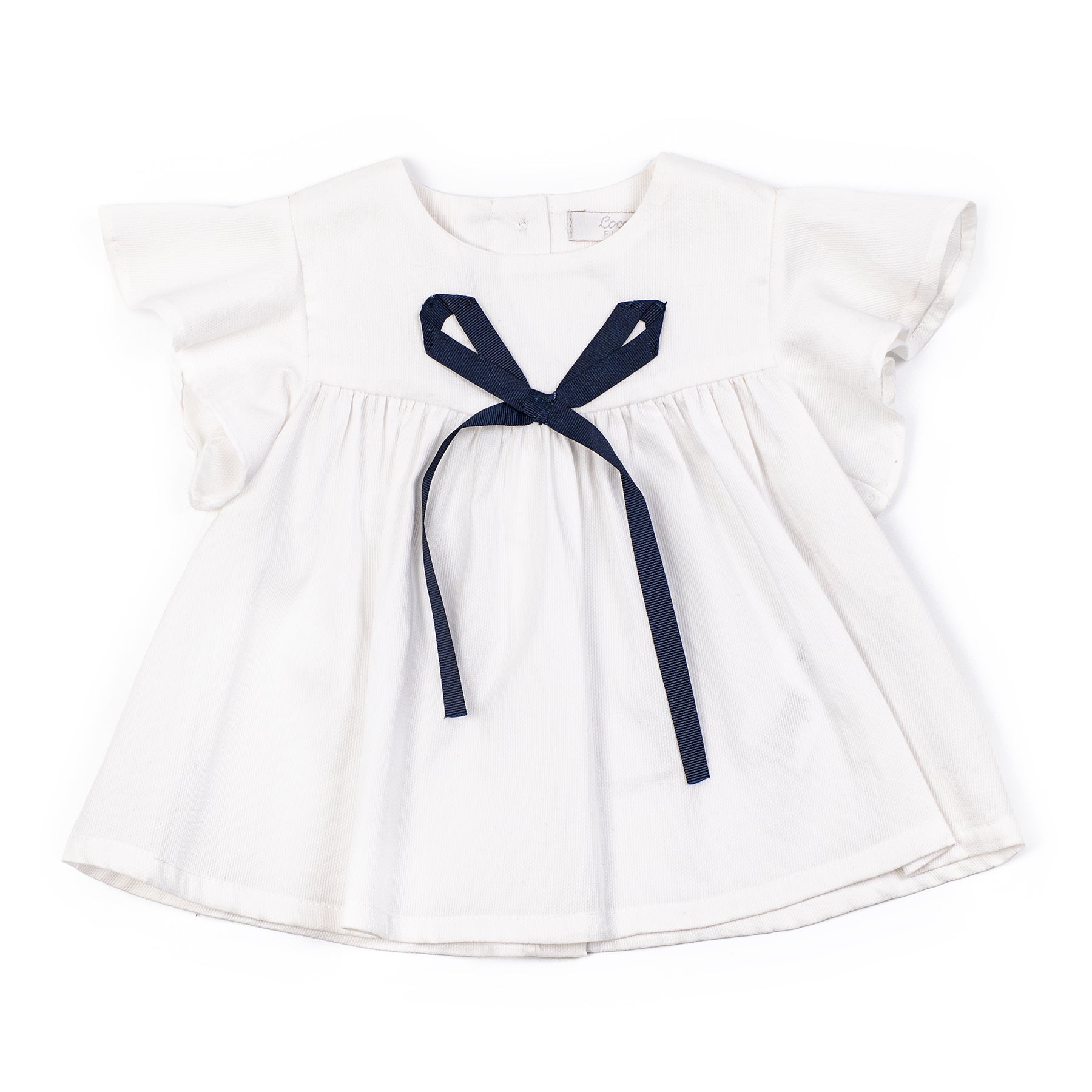 White dress with a navy blue ribbon on a white background