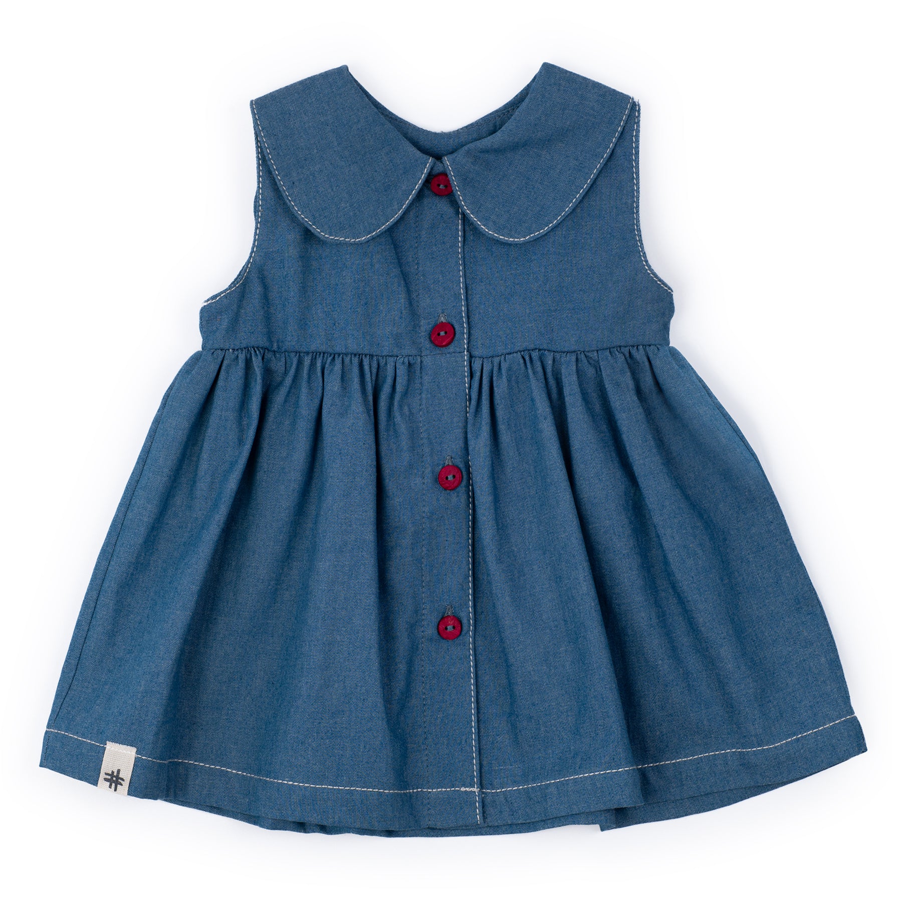Blue denim dress with red buttons on a white background
