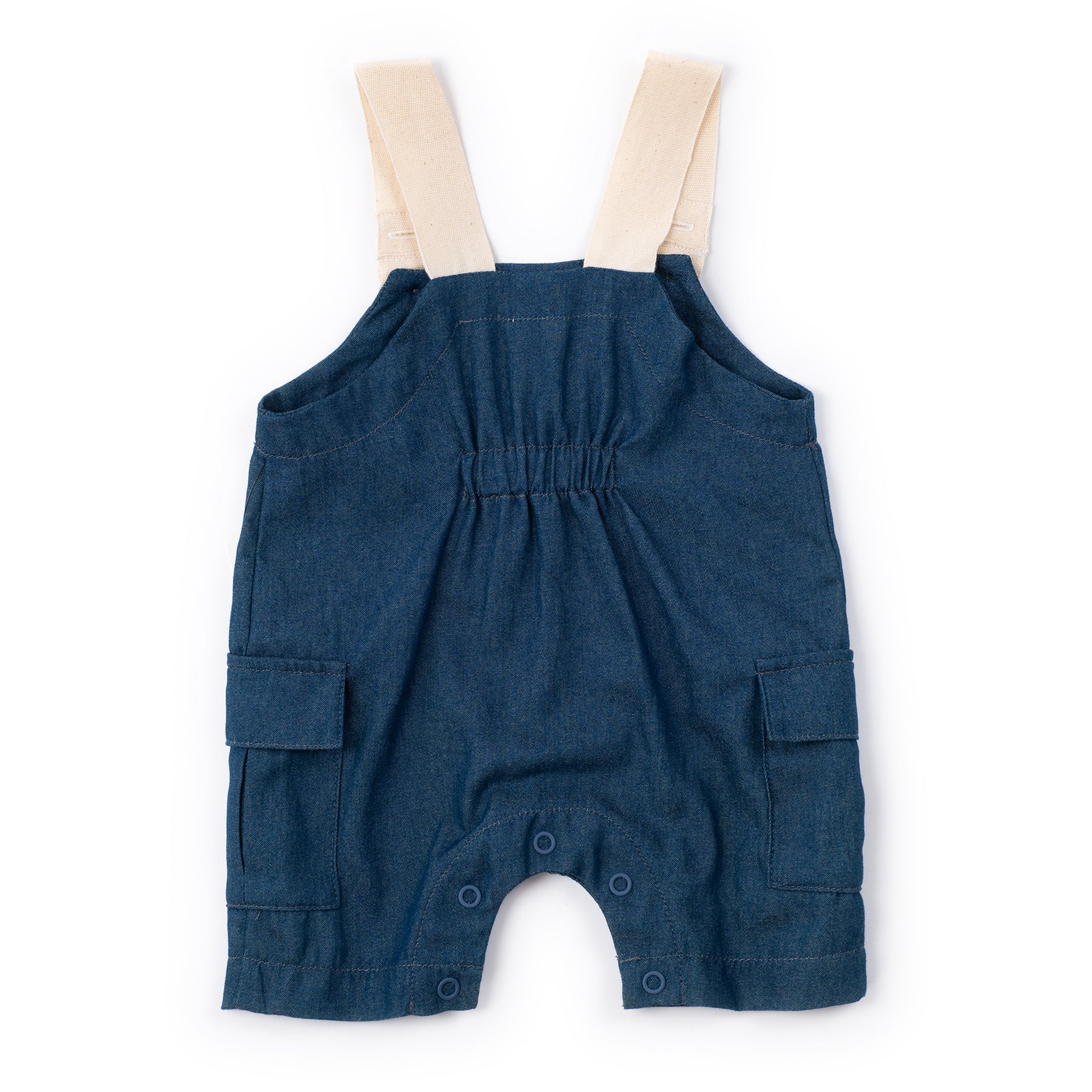 Blue denim baby romper with beige straps on a white background