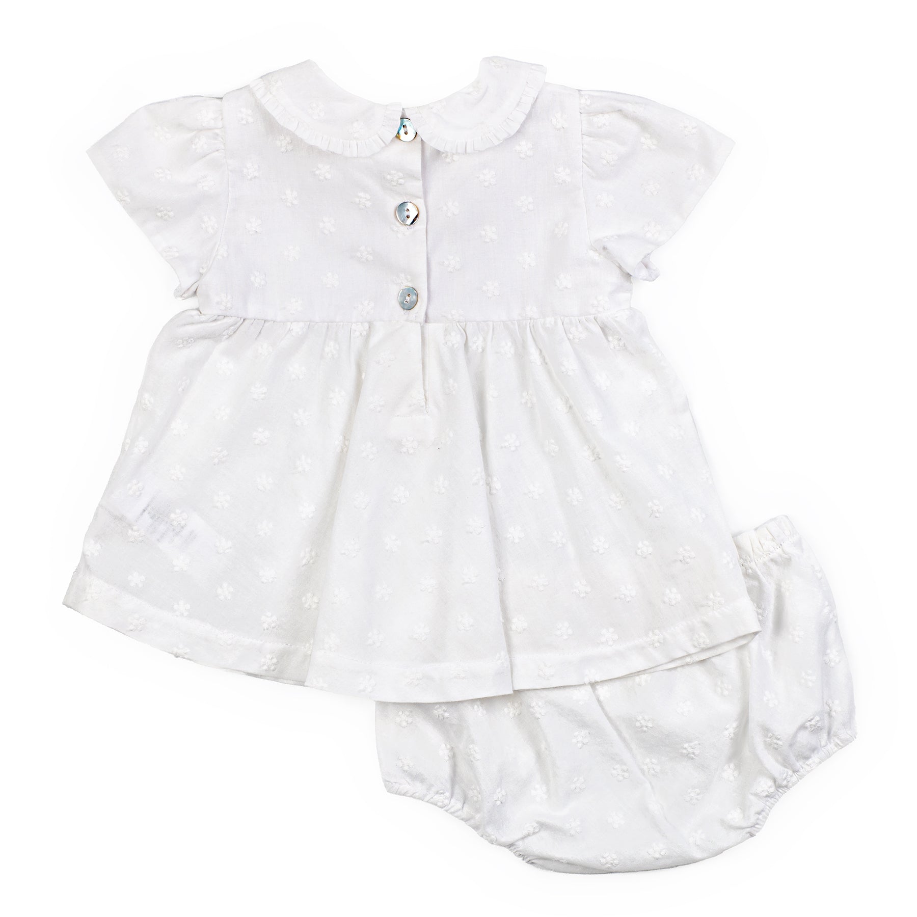 White baby dress with ruffled collar and bloomers on a white background