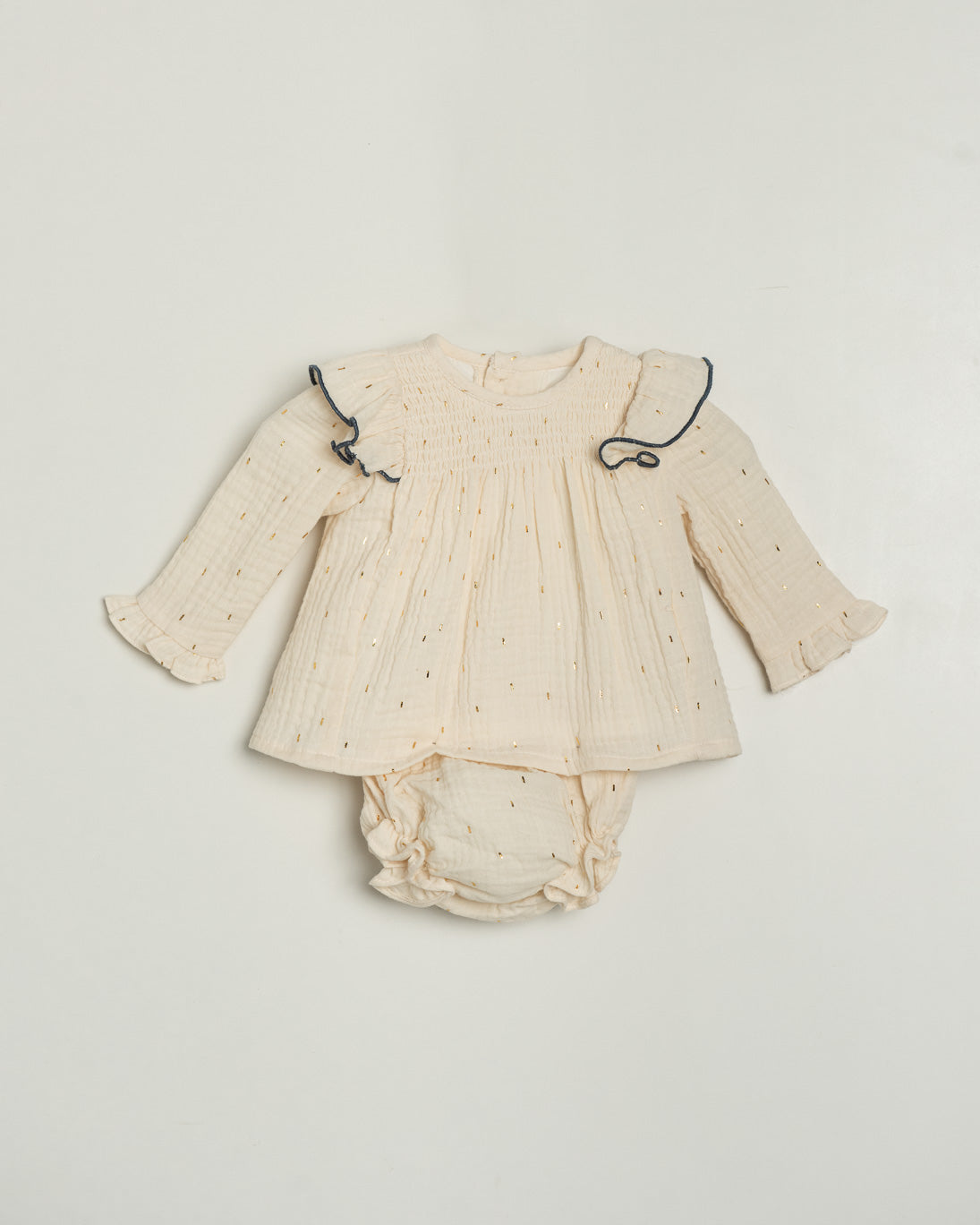 Baby outfit with long-sleeve top and diaper on a light gray background