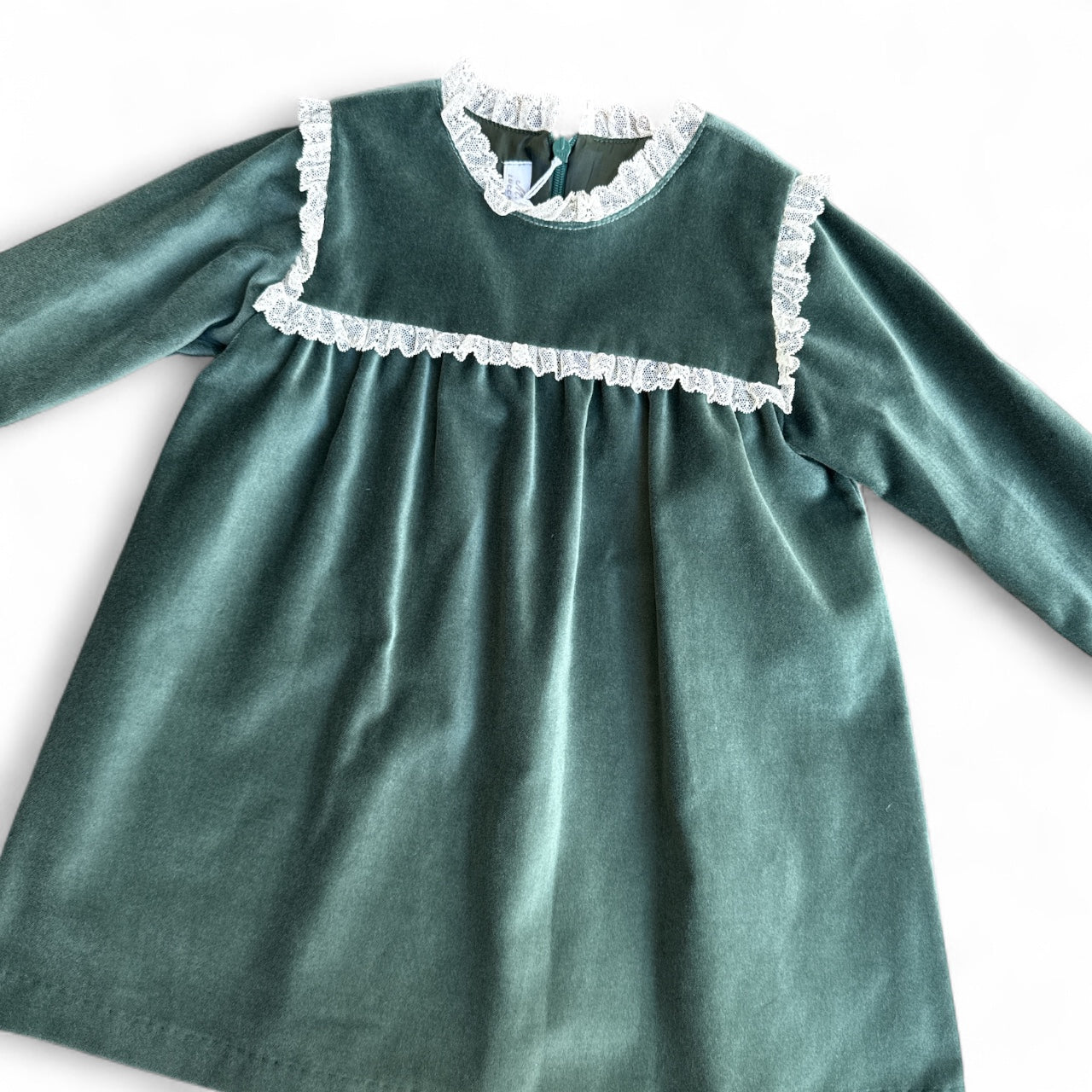 Green dress with lace trim on a white background