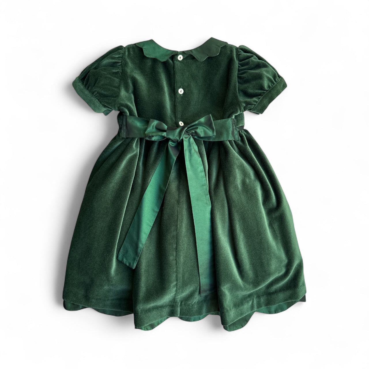 Green velvet dress with a belt on a white background
