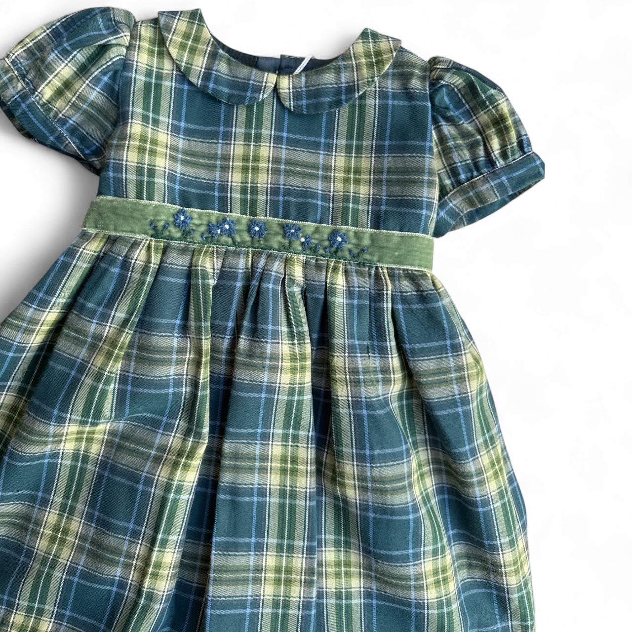 Green plaid dress with a decorative belt on a white background