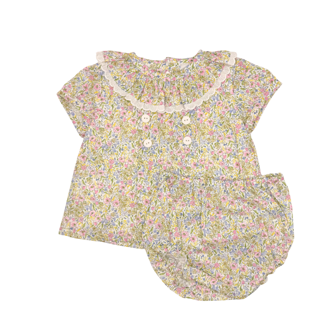 Floral baby set with ruffled collar on a white background