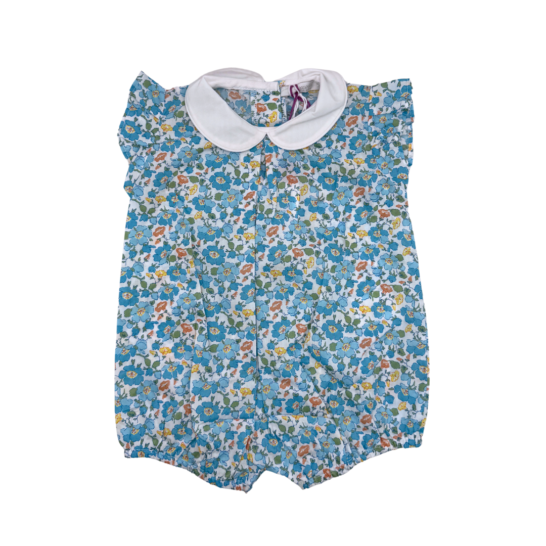 Floral baby romper with a white collar on a white background