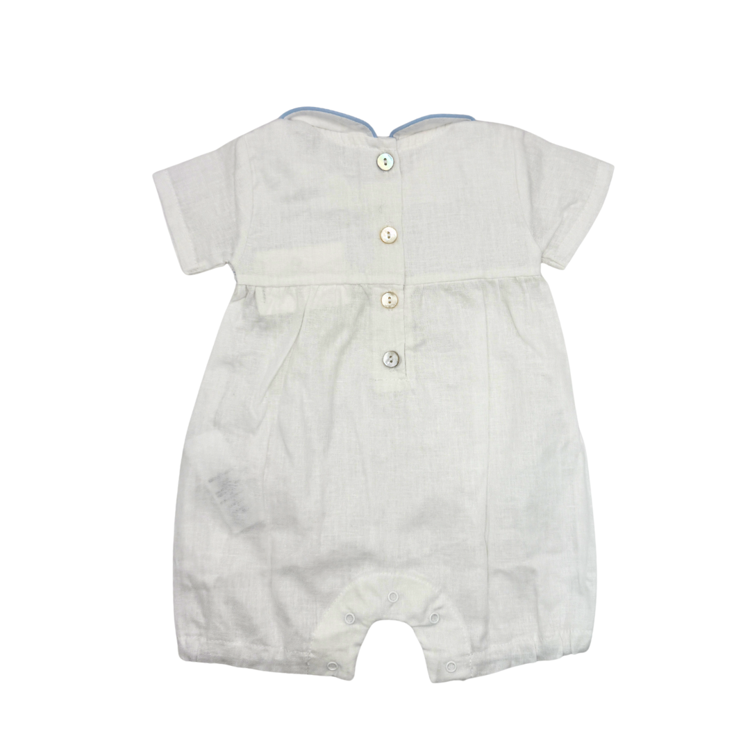 White baby romper with buttons on a white background