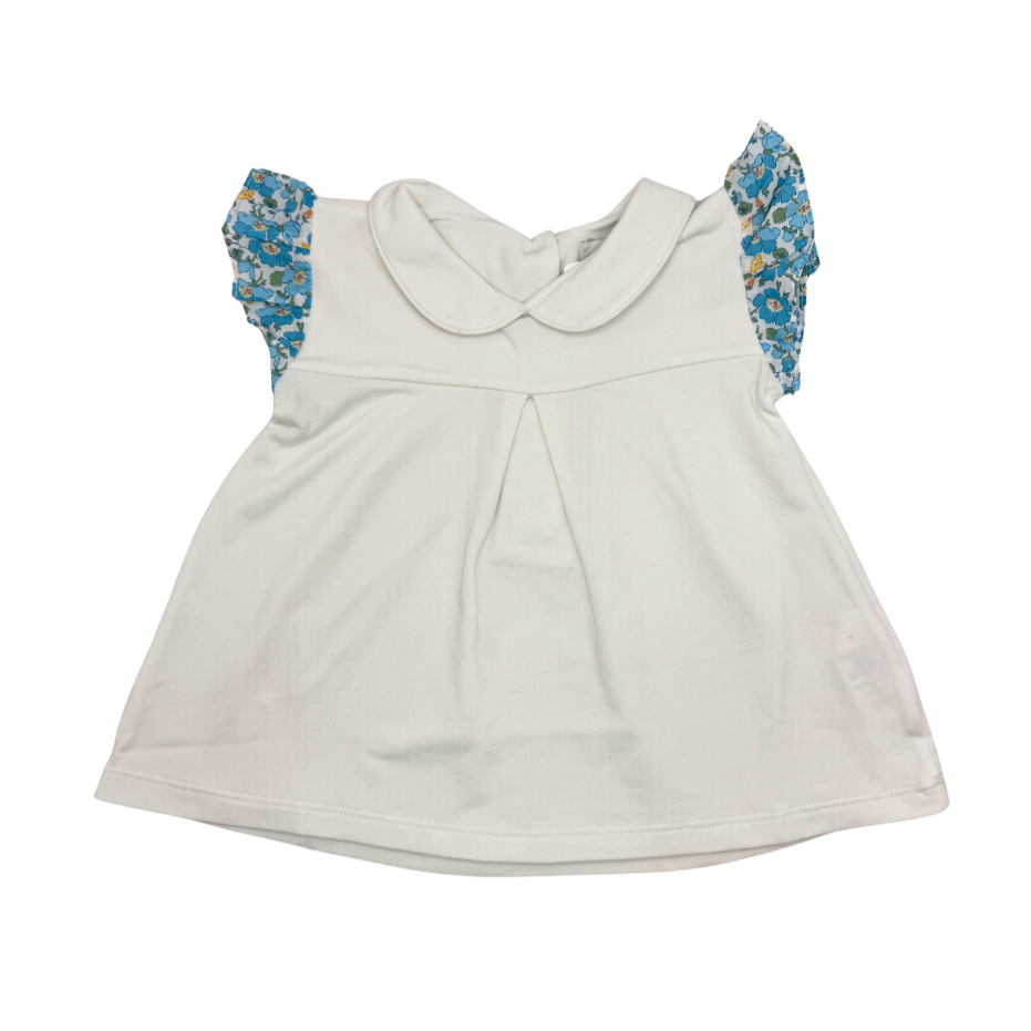 White dress with floral blue sleeves on a white background