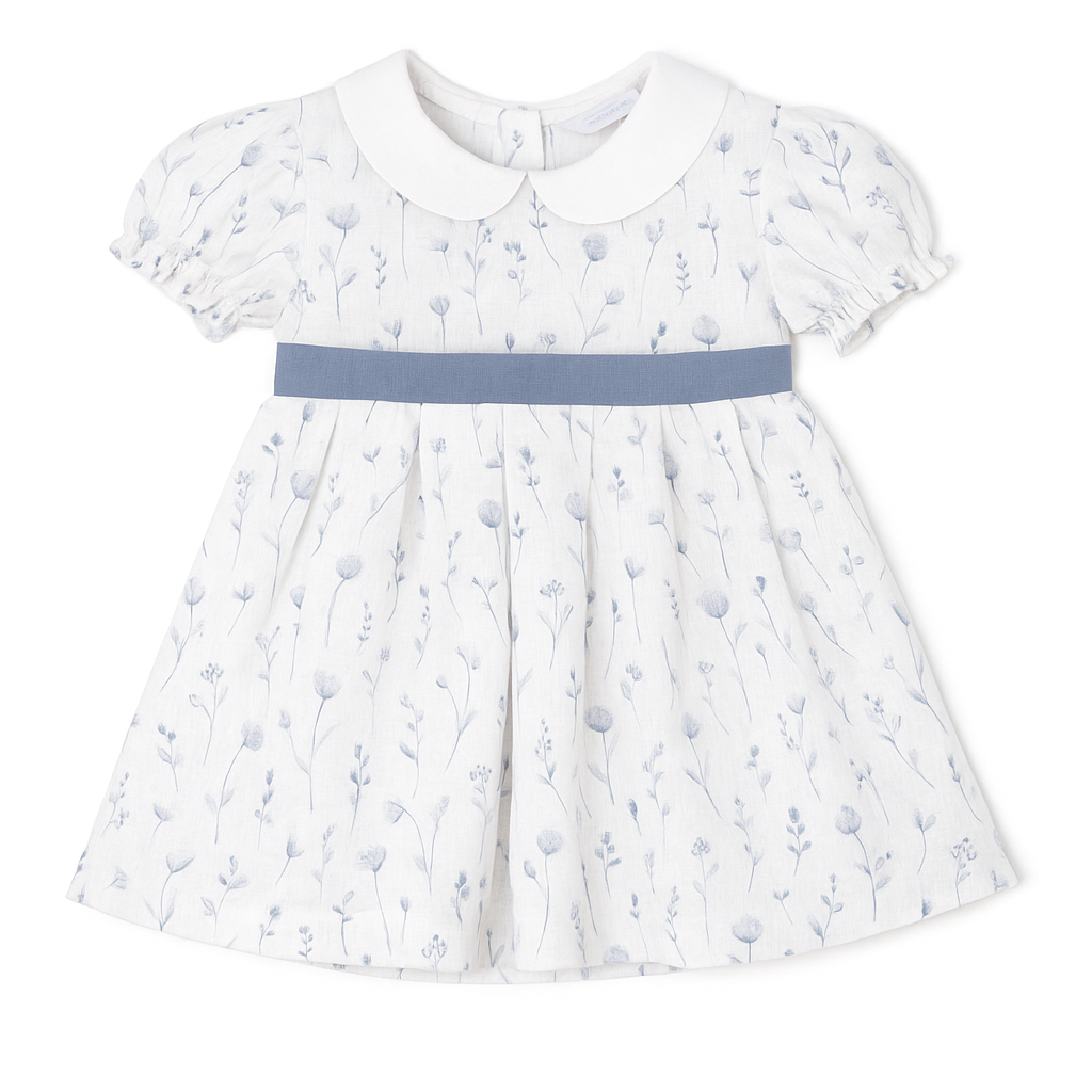 White dress with blue floral pattern and blue belt on a white background