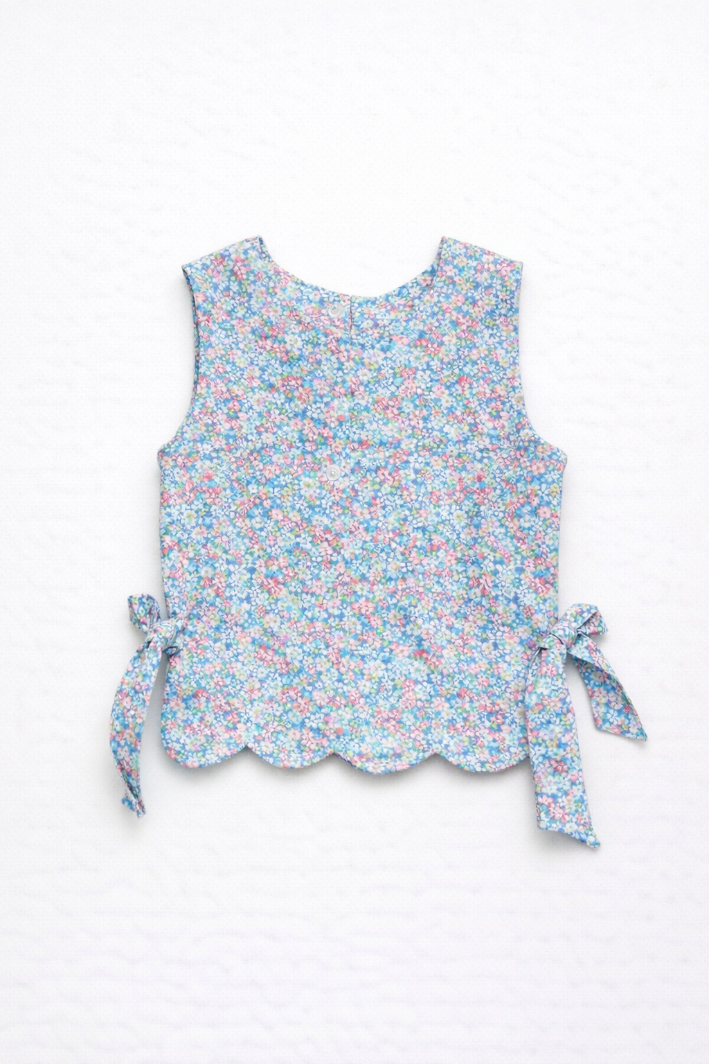 Floral sleeveless top with ribbon details on a white background